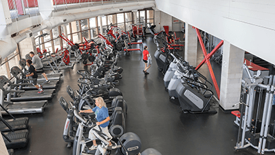fitness room with people working out on various machines